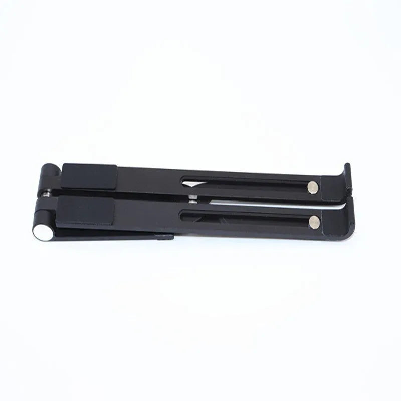Black aluminium notebook stand supporting a silver laptop on a desk.