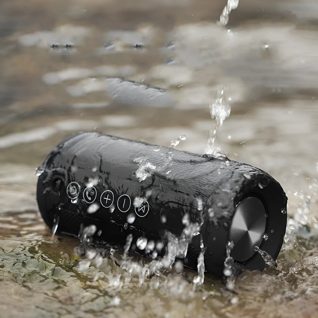 Compact waterproof Bluetooth speaker in camouflage colour, showing control buttons and sealed ports.