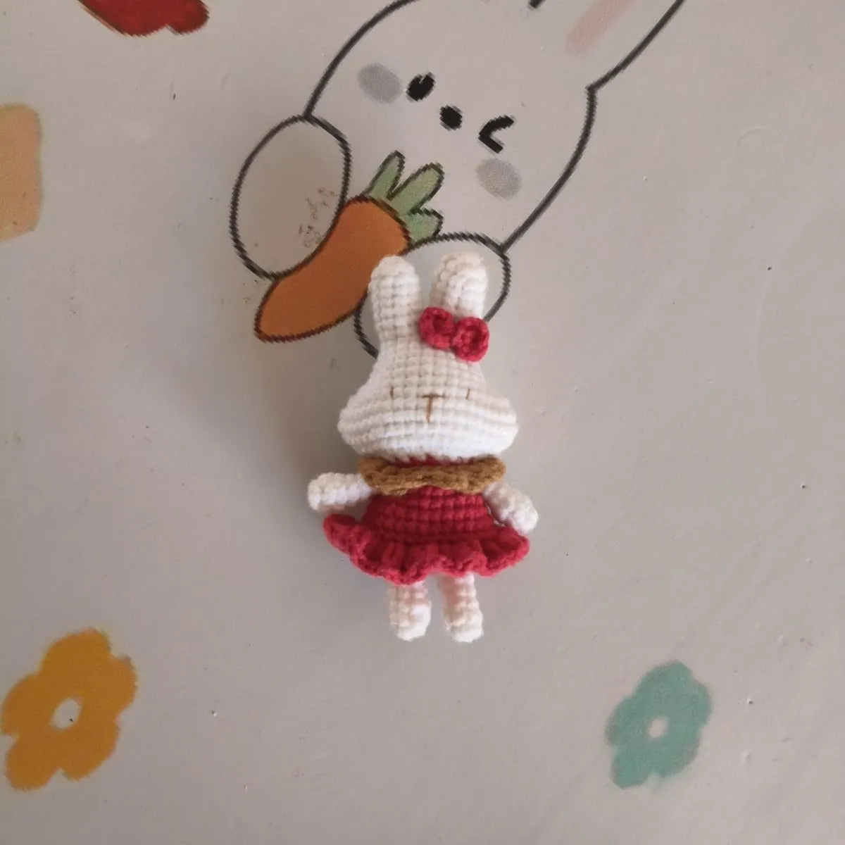 Hand-crocheted wool rabbit key chain with cute design, shown in two style options