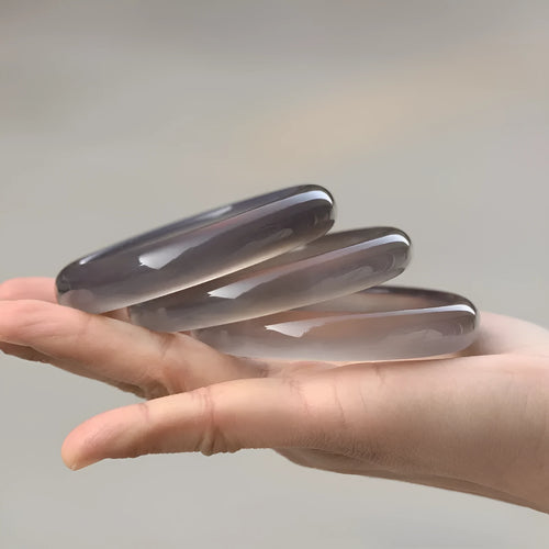 Dark grey Brazilian iced chalcedony agate bracelet with natural pattern, shown on a wrist.
