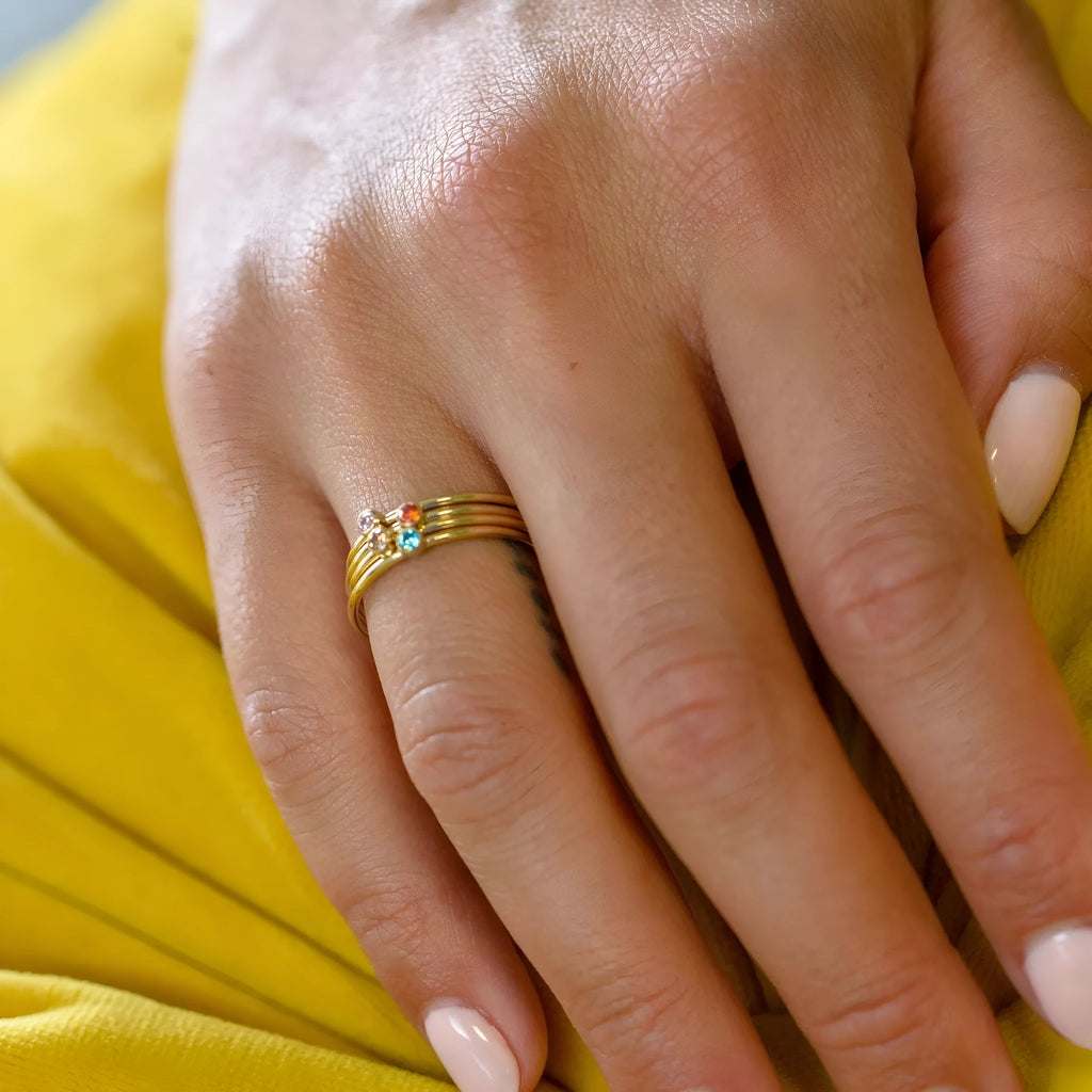 Geometric engraved titanium steel ring with a December birthstone colour overlay and gold electroplated finish.