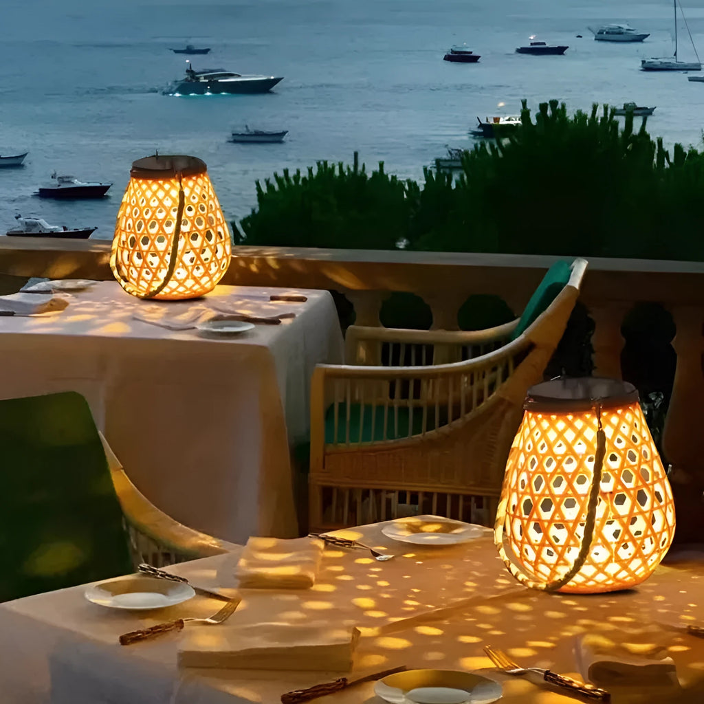 Outdoor solar lantern with imitation bamboo weaving shade casting decorative light patterns in a garden setting