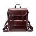 Black two-layer cowhide leather computer backpack for women with internal lining.