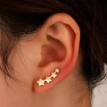 A pair of copper leaf-shaped clip-on earrings for women with a KC Golden Star finish.