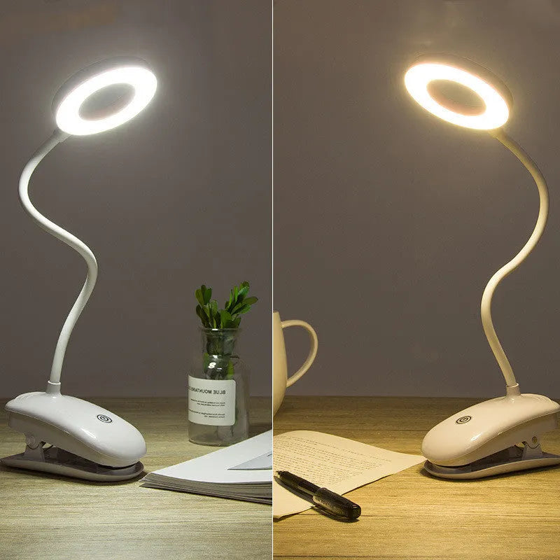 Modern clip-on rechargeable LED desk lamp with touch switch and plastic shade in use on a desk.