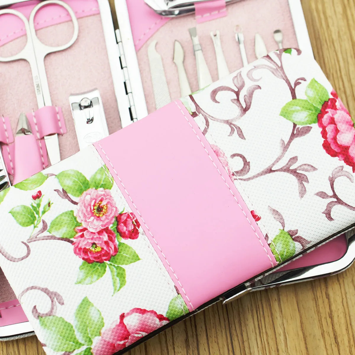 Stainless steel 12-piece nail clipper set with pink flower design including nail scissors and clippers