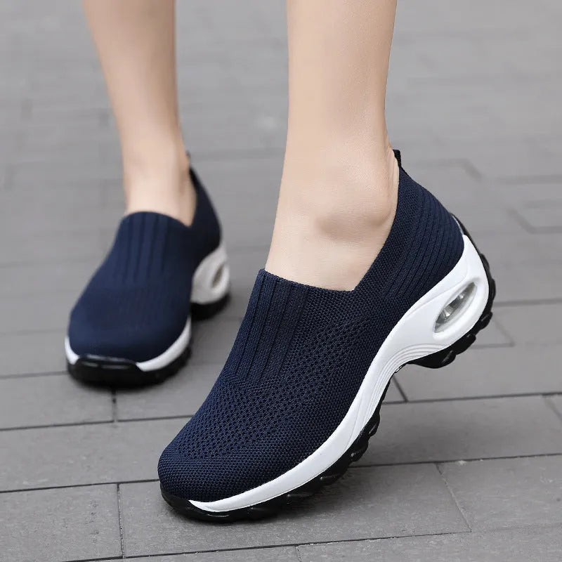 Women's mesh slip on air cushion sneakers in black, with low top and thick bottom, side view