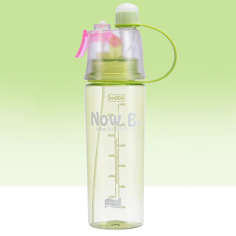 Green portable sports mist spray cup with transparent body, volume scale, handle, and spray mouth.