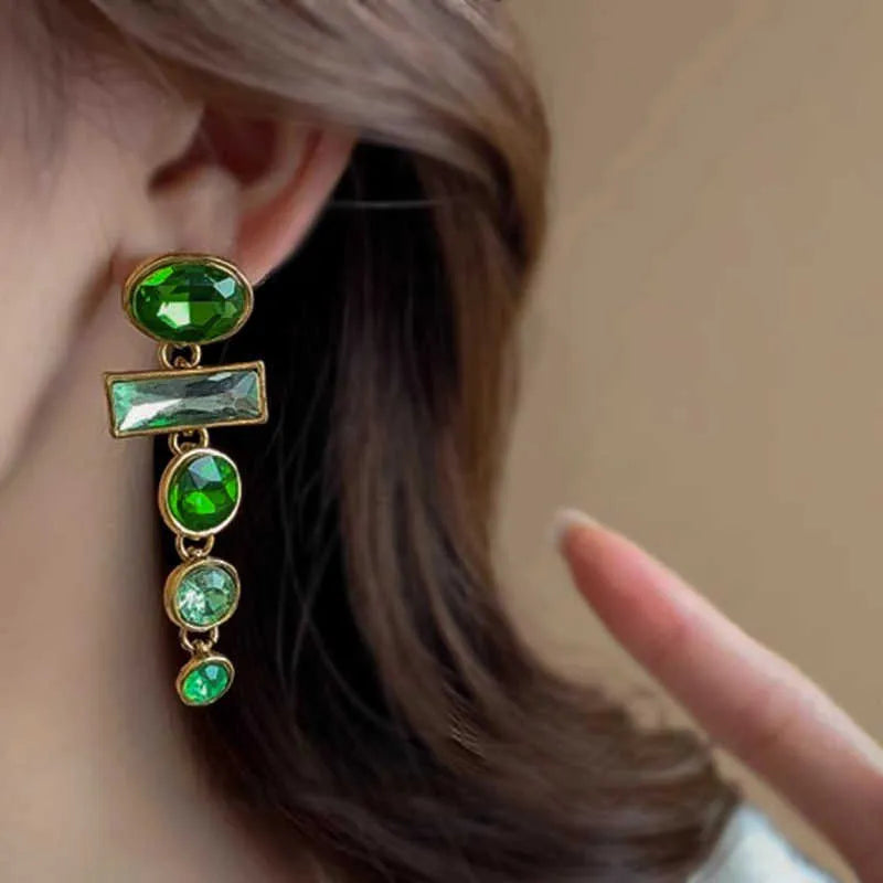 Pair of green gradient geometric alloy earrings with a tassel and inlaid zircon stone details on a white background.