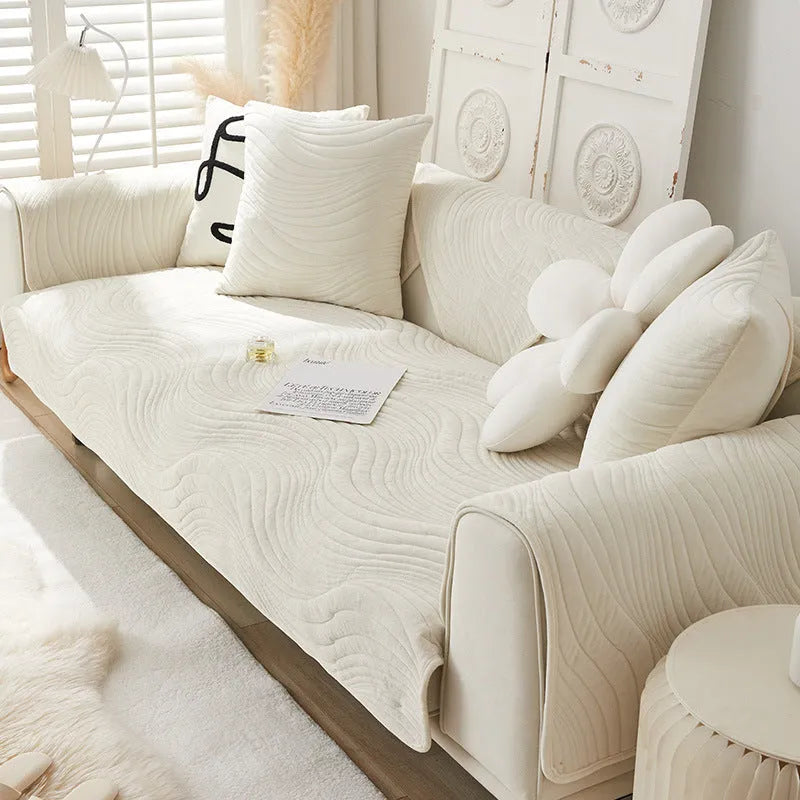 Thickened non-slip flannel sofa cover with geometric pattern in beige on a modern sofa