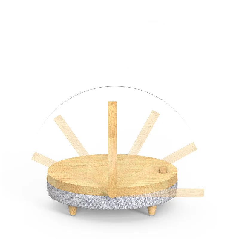 Wireless charging night light with Bluetooth speaker showing marble pattern finish and mobile phone resting in integrated holder