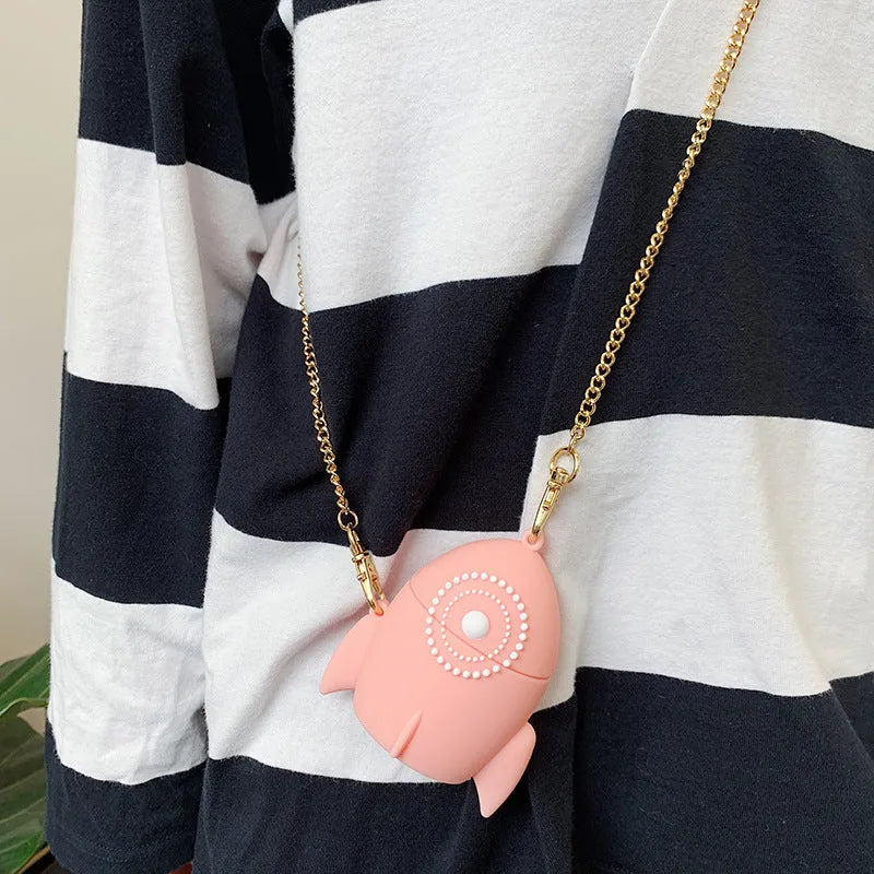 Pink silicone AirPods case with raised rocket design next to black plain version