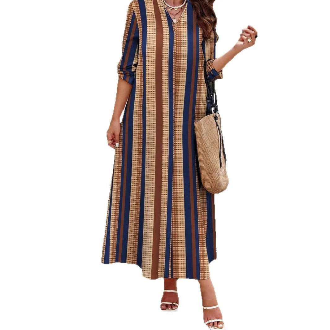 Camel coloured women's long dress with vertical stripes, V-neck, and long sleeves on a hanger.