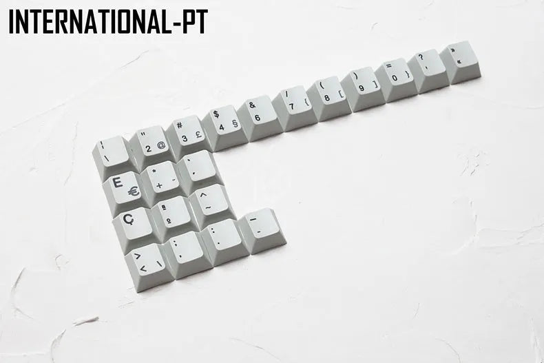 Keyboard with sublimation-printed international symbols for multiple European language layouts on keycaps.
