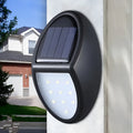 Black solar-powered LED wall light with automatic light sensor for outdoor use