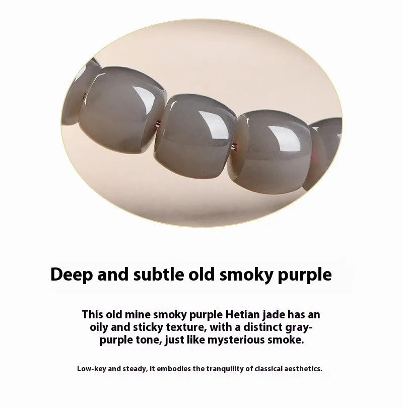 Natural smokey violet Hetian jade straight cut bead bracelet on a wrist.
