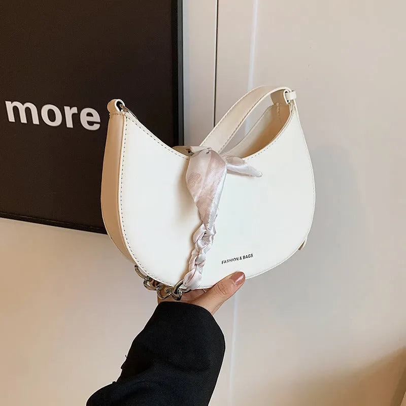 Small PU saddle shoulder bag with sandwich pocket and phone compartment, shown in black, brown, coffee, green, khaki or white.