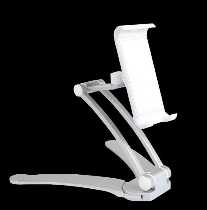 Silver aluminium desktop tablet stand holding a tablet, showing 360-degree rotation and dual adjustable clip design.