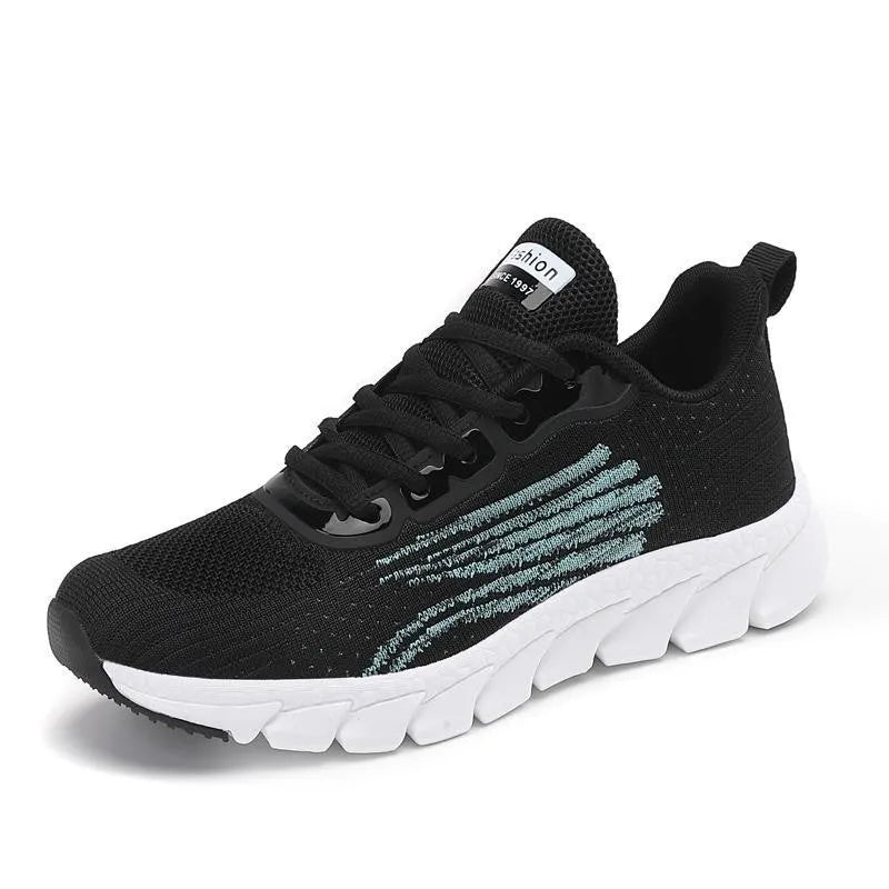Low-top black and white running sneakers with cross-strap detail and flat MD sole.
