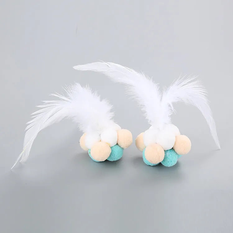Cat toy feather bouncy ball with colourful pink feathers and blue white feathers for interactive play