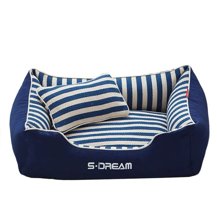 Navy stripes washable dog kennel mat with a blue mini pillow inside a crate.