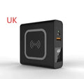 Super QI Power Bank showing fold-out UK, EU, US, and AU plug pins next to a smartphone on its wireless charging surface.