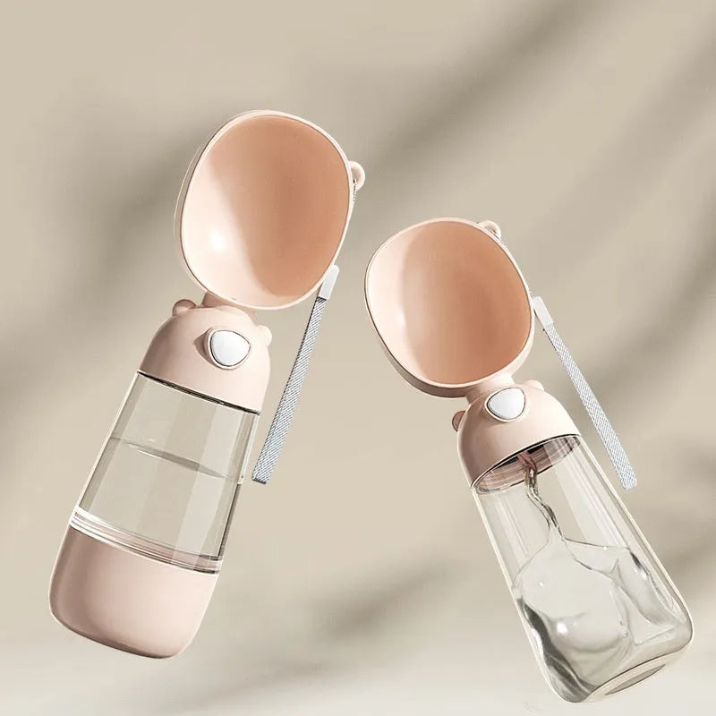 Portable dog water bottle with a folding bowl attached, shown in yellow, pink, and brown colours.