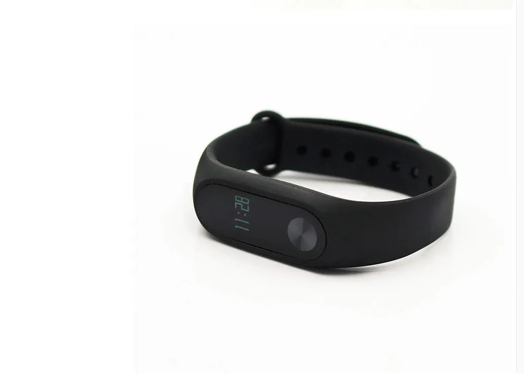 Xiaomi Mi Band 2 black fitness tracker with OLED screen on a wrist.