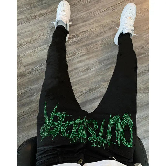 Men's black fashion ripped jeans with slim fit and distressed detailing, shown from front