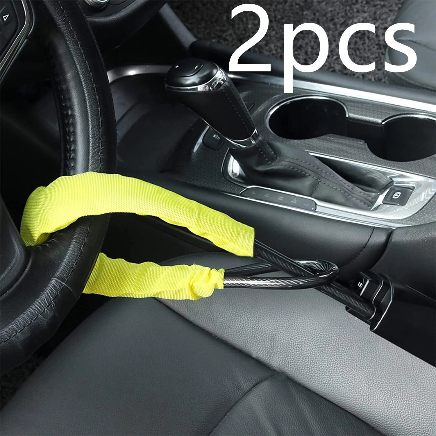 Red steel car steering wheel security lock with coiled cable on a car seat.