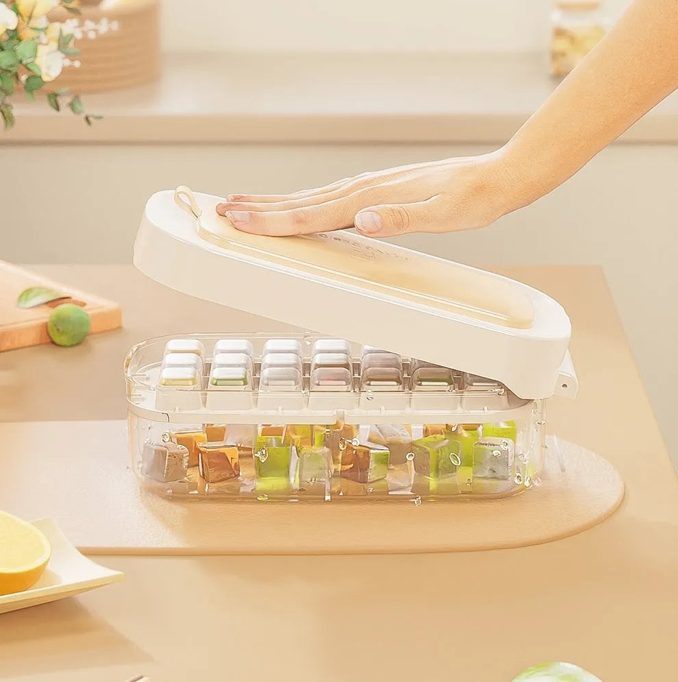 A blue high-capacity ice cube tray with a lever mechanism for easy demoulding and a stored ice shovel.