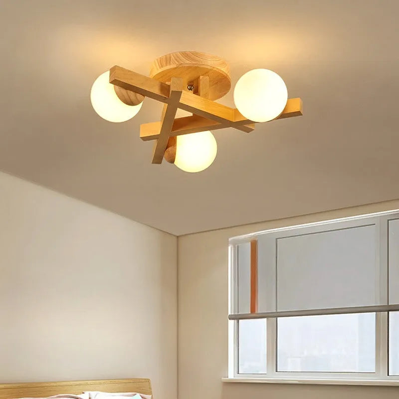Modern black and copper three-headed pendant ceiling light with adjustable arms hanging over a wooden table