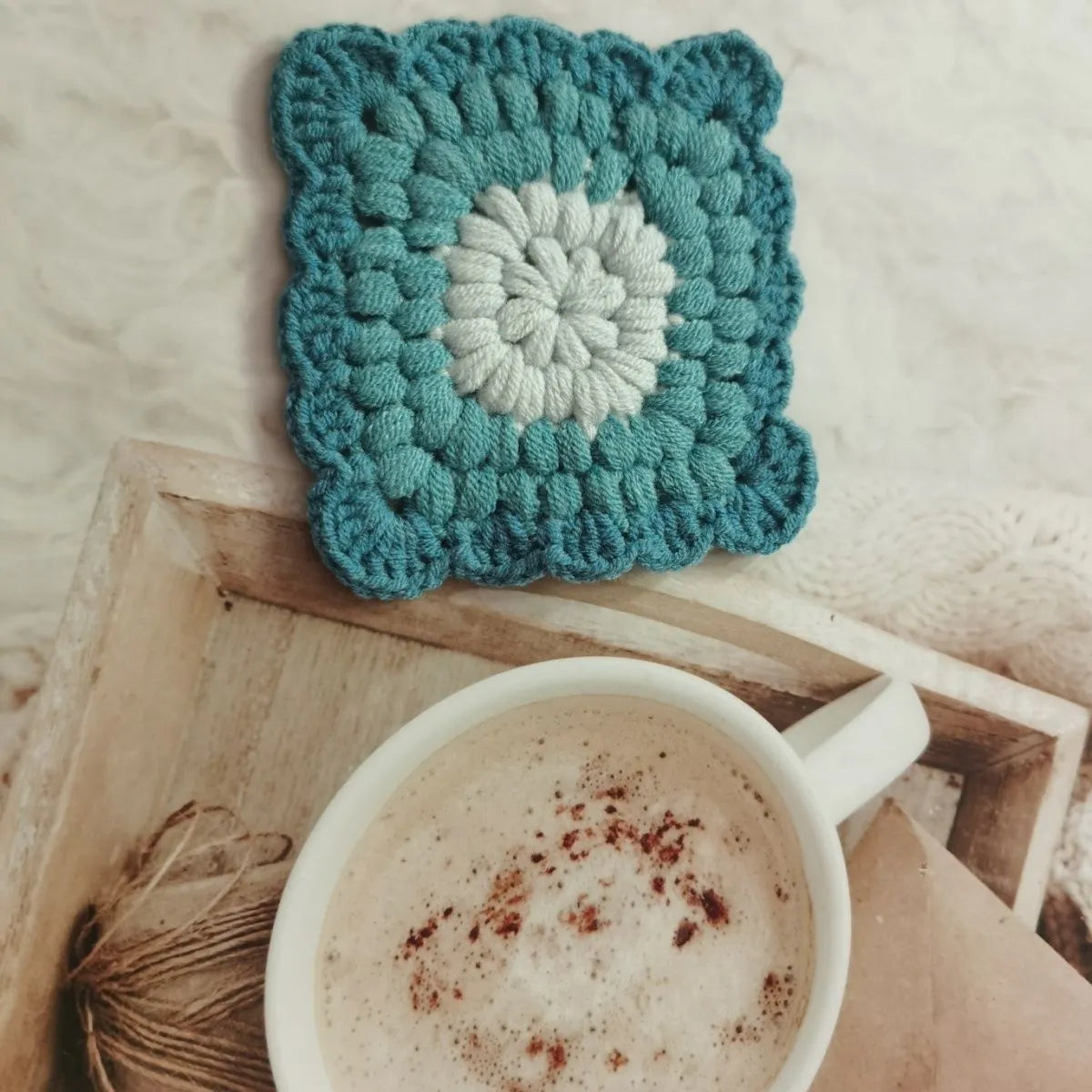 Crocheted wool insulated cup placemat with grandmother lattice pattern in choice of colours