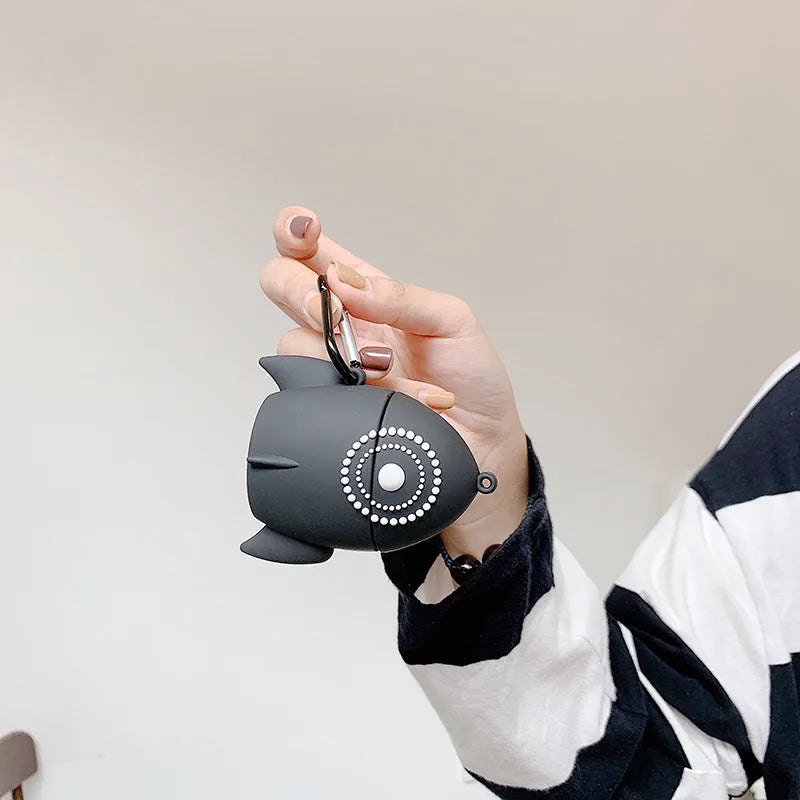 Pink silicone AirPods case with raised rocket design next to black plain version