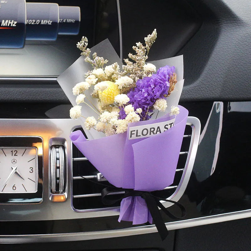 Mini dried flower bouquet clipped onto a car air vent, showing pink and white floral style.