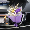 Mini dried flower bouquet clipped onto a car air vent, showing pink and white floral style.