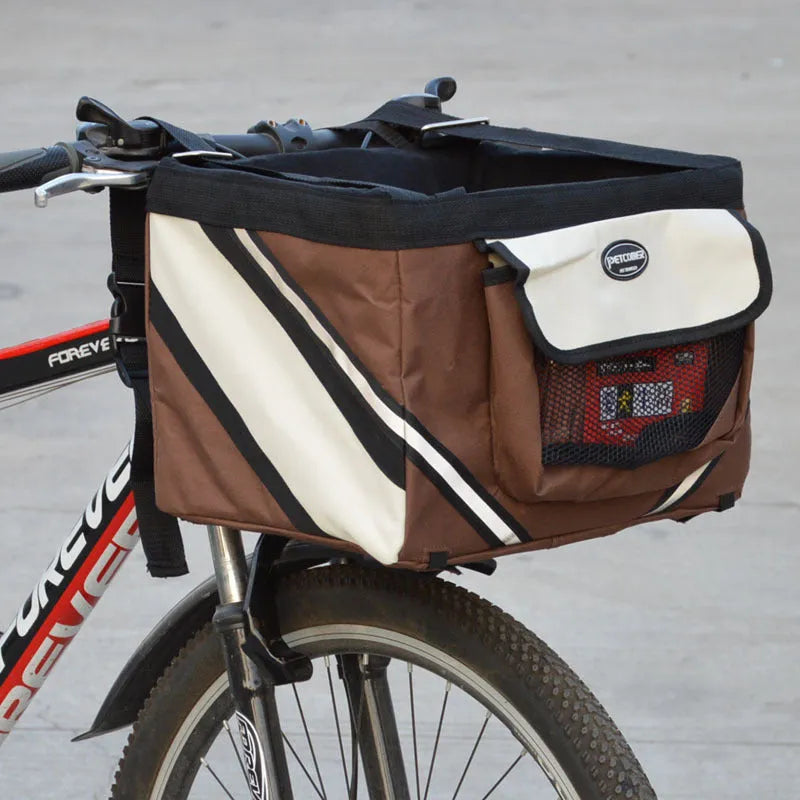 Pet bicycle carrier in Oxford material for small cats and dogs, attached to handlebars with traction hook visible