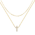 Close-up of a sterling silver double layer twin diamond cross pendant necklace on an adjustable chain.
