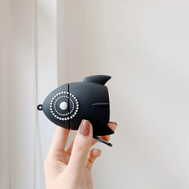 Pink silicone AirPods case with raised rocket design next to black plain version