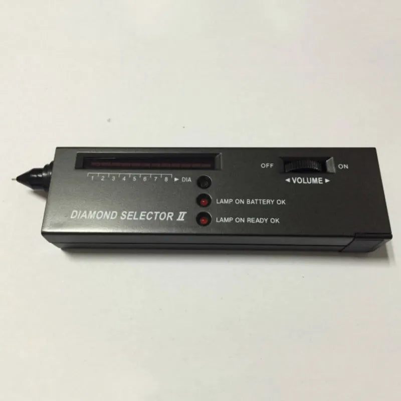 Black handheld diamond thermal conductivity meter with metal probe on a white background.