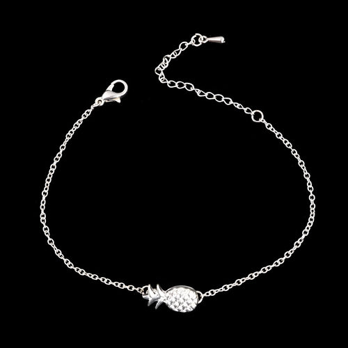 Gold and silver alloy bracelet with a pineapple charm on an adjustable band.