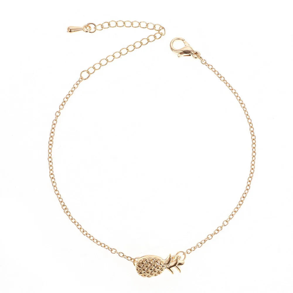 Gold and silver alloy bracelet with a pineapple charm on an adjustable band.