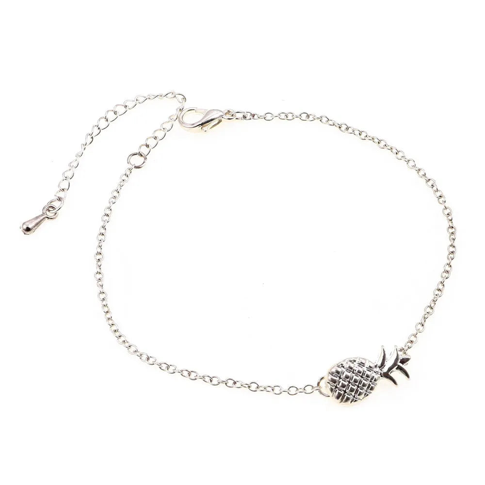 Gold and silver alloy bracelet with a pineapple charm on an adjustable band.