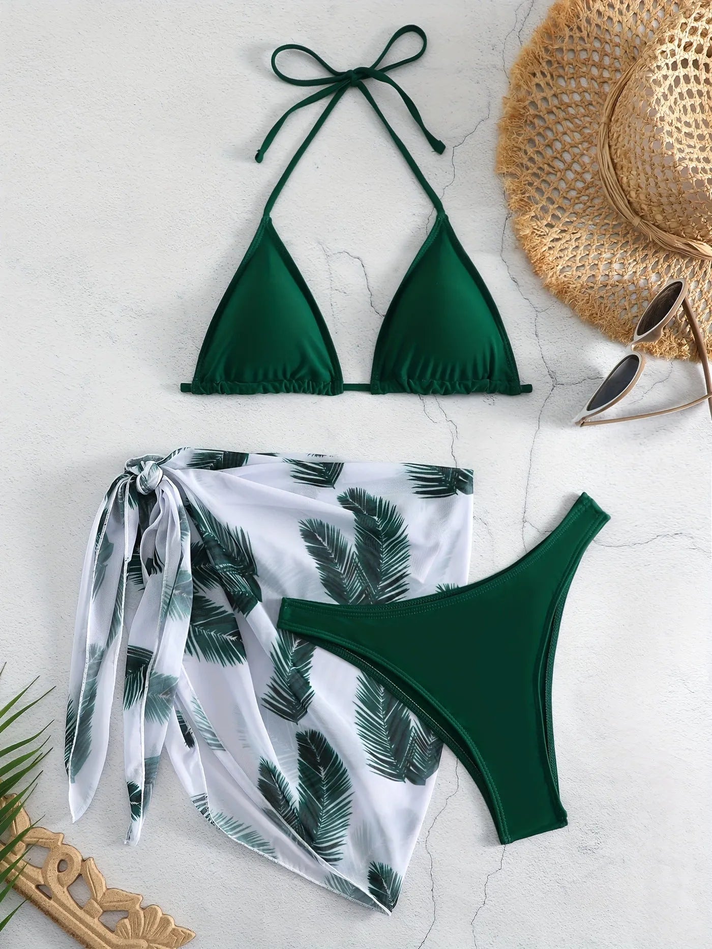 Women's orange polyester bikini set with a matching printed gauze skirt laid flat.