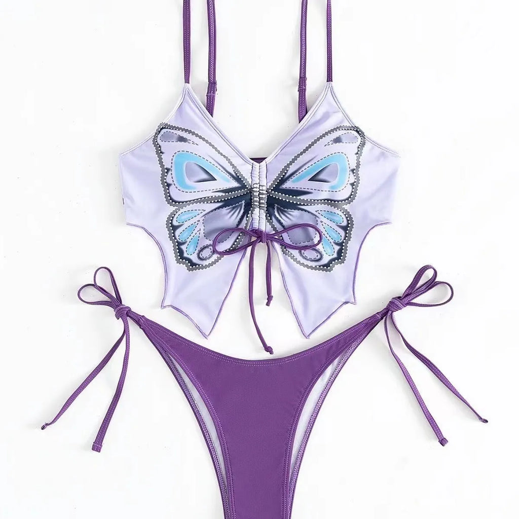 Women's purple split bikini swimsuit with bow detailing on the front, showing sleeveless top and briefs.