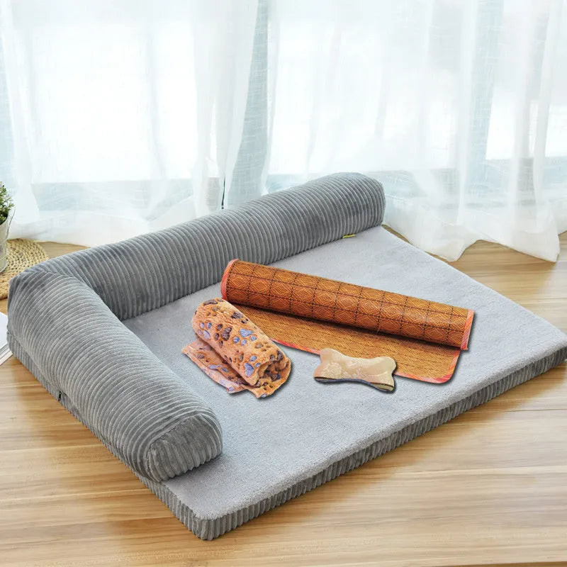 A corduroy dog sofa bed with a raised bolster side, shown in a grey colour on a wooden floor.
