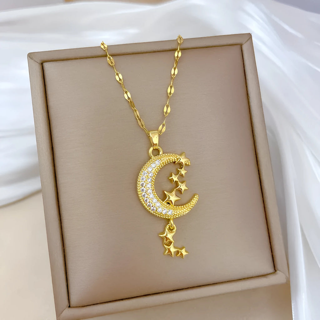 Moon tassel necklace with full diamond geometric pendant on a stainless steel chain, showing tassel detail.