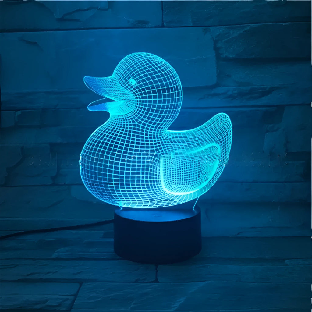 Little yellow duck 3D night light on a table, showing its cartoon design and colourful LED glow.