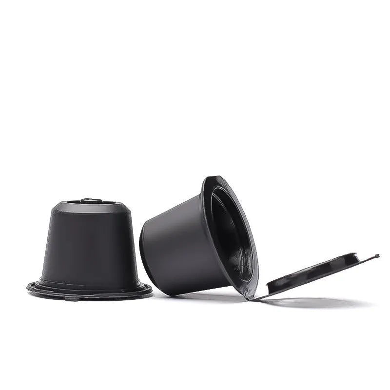 Six plastic coffee filter cups in black, red, and brown with a spoon, reusable shell capsule design for home brewing