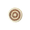 Round Japanese straw placemat with tassel edge on dining table